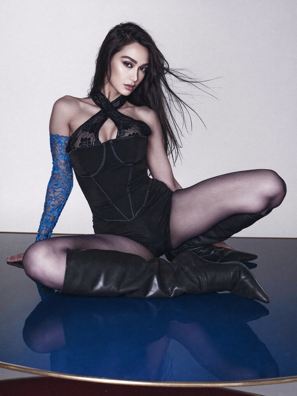Ati Mansoury in a full-body black and blue editorial fashion pose
