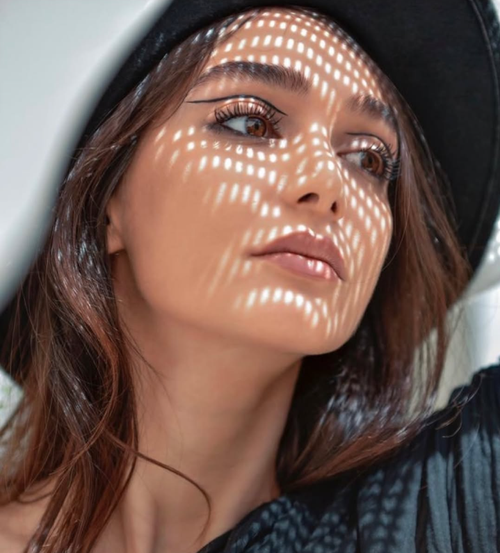 Conceptual close-up portrait of Ati Mansoury with patterned light